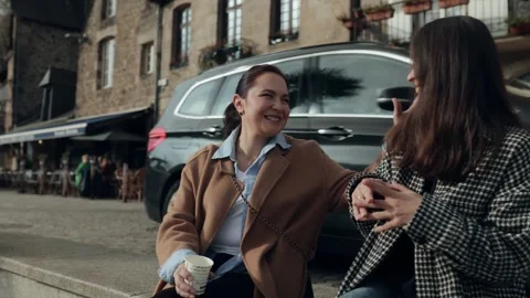 Two close friends share a spontaneous and engaging conversation on a beautiful Stock Footage 335165070