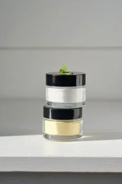 Two closed jars of enzime face scrub. Stock Photos
