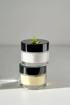Two closed jars of enzime face scrub. Stock Photos