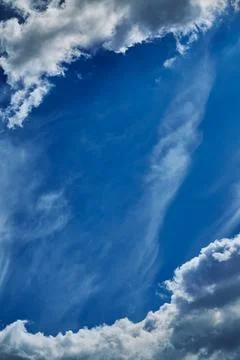 Two clouds on the edges of the frame and sky with haze between them, beautifu Stock Photos