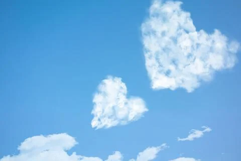 Two clouds in heart shape soar in blue sky. Concept of love, romance and happ 스톡 사진