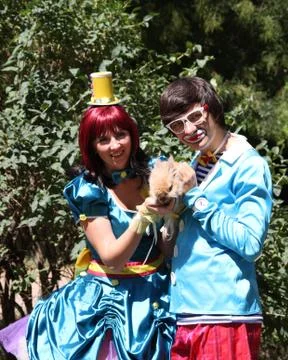 Two clowns with a rabbit in the park  Stock Photos