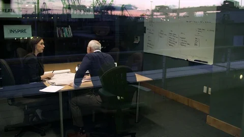 Two co-workers having a meeting in a conference room 動画素材 77080336