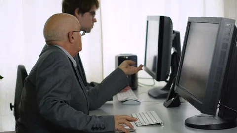 Two Co-Workers in Office Chatting Together While Working on Computer Stock Footage 113274857