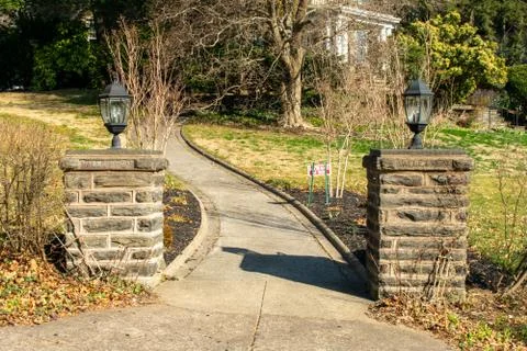 Two Cobblestone Pillars With a Paved Path Running Between Them Foto stock