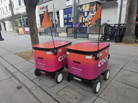 Two Coco Delivery Robots on Sidewalk Stock Photos