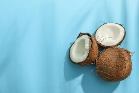 Two coconut one of which split on color background Stockfoto's