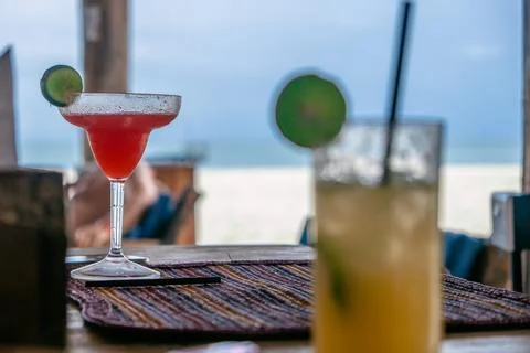 Two coctails in beach bar, beach and ocean in background Zanzibar 스톡 사진