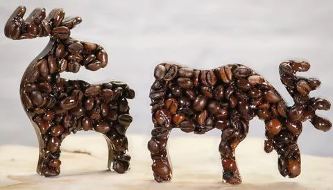 Two Coffee Bean Elk Figures on Light Background Stock Photos