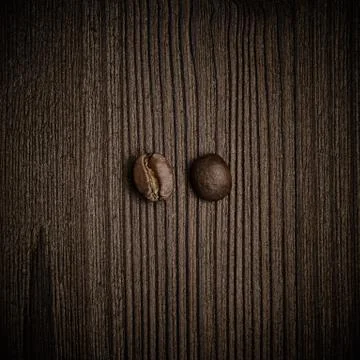 Two coffee beans in white background, top view. Stock Photos