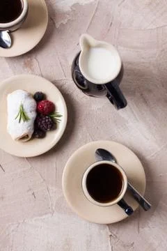 Two coffee cup roll with cream and berries milk Stock Photos