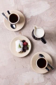 Two coffee cup roll with cream and berries milk Stock Photos