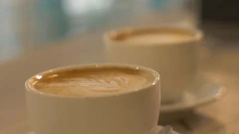 Two coffee cup on table in cafeteria close up. Cups with cappuccino coffee Stock Footage 90678592