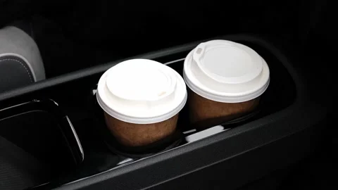 Two coffee cups in car console panel Stock Footage 160157001