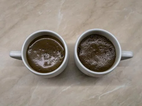 Two coffee cups on the kitchen table, top view Stock Photos
