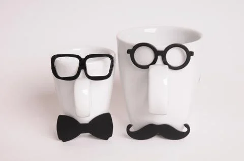Two coffee cups in mans image. Hipster style, glasses, mustache, bow tie Stock Photos