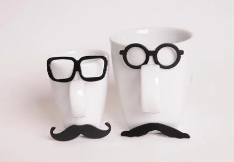 Two coffee cups in mans image. Hipster style, glasses, mustache Stock Photos