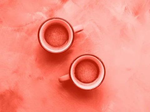 Two coffee cups. Minimal flat lay. Coral tone Stock Photos