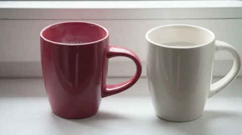 Two coffee cups - red and white Stock Footage 44549384