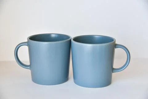 Two coffee cups on a white table in a bright kitchen Stock Photos