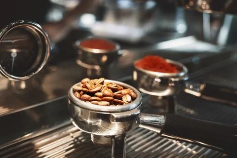 Two coffee holders one with fresh ground coffee another with roasted beans Stock-Fotos