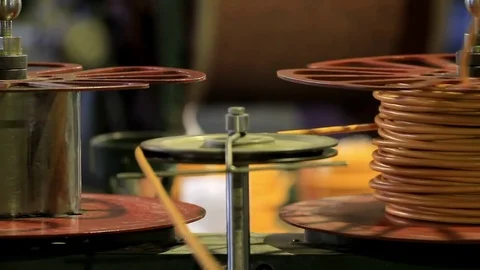 Two coils with orange cable spinning Stock Footage 76951141