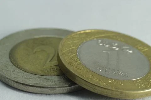 Two coins close up on a white background Stock Photos