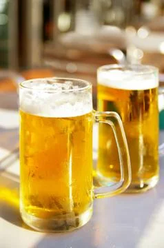 Two cold pints of beer at an outdoor cafe Stock Photos
