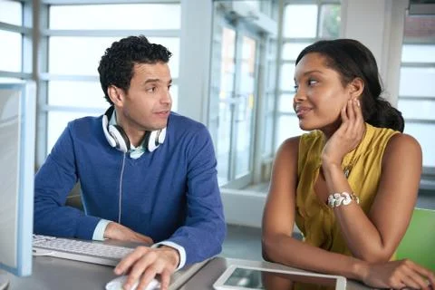 Two  colleages discussing ideas using a tablet and computer Stock Photos