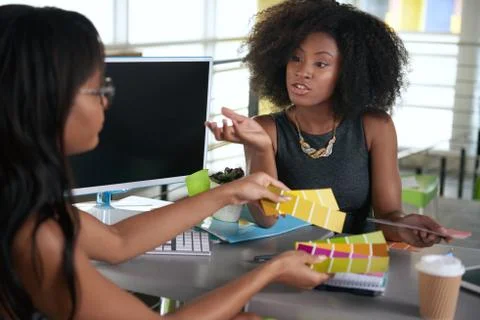 Two  colleages discussing ideas using a tablet computer Stock Photos