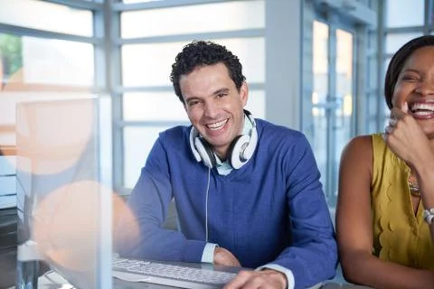 Two  colleages discussing ideas using a tablet and computer Stock Photos