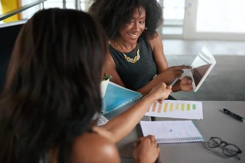 Two  colleages discussing ideas using a tablet computer Stock Photos