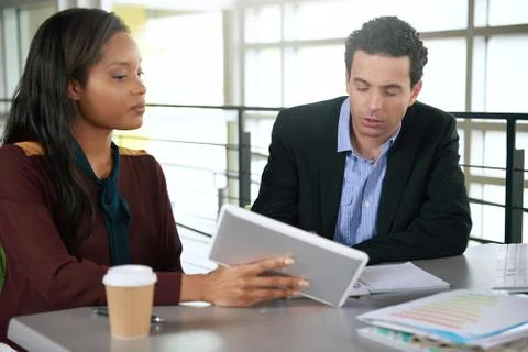 Two  colleages discussing ideas using a tablet Stock Photos
