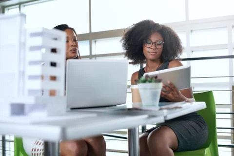 Two  colleages discussing ideas using a tablet computer Stock Photos