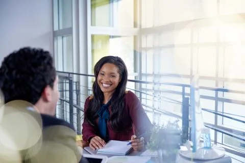 Two  colleages discussing ideas using a tablet and computer Stock Photos