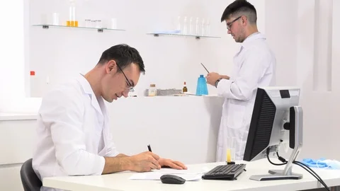 Two colleagues and pharmaceutical workers invent new drugs Stock Footage 118045272