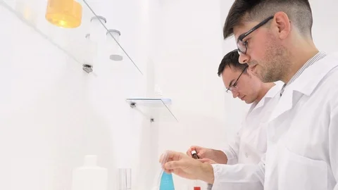 Two colleagues and pharmaceutical workers invent new drugs Stock Footage 118081415