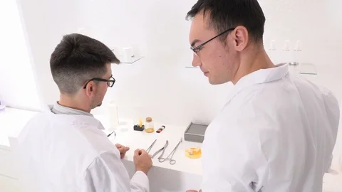 Two colleagues and pharmaceutical workers invent new drugs Stock Footage 118119729