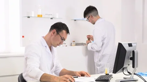 Two colleagues and pharmaceutical workers invent new drugs Stock Footage 118120248