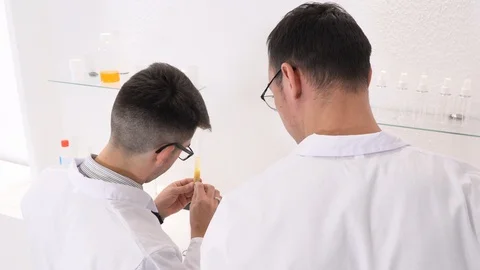 Two colleagues and pharmaceutical workers invent new drugs Stock Footage 118120402