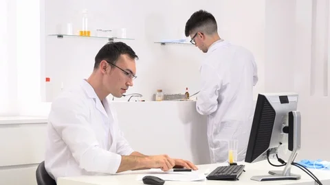 Two colleagues and pharmaceutical workers invent new drugs Stock Footage 118371110