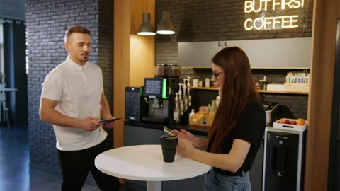 Two colleagues are studying a project on a tablet in an office cafe Stock Footage 195208364