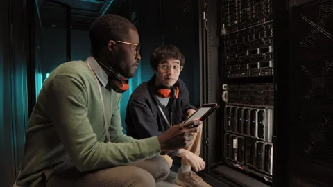 Two Colleagues Checking Work of Rack Server Cabinet 動画素材 149654850