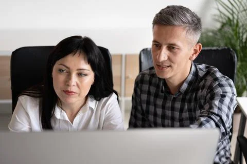 Two Colleagues Collaborating on a Project in Modern Office Stock Photos