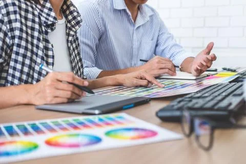Two colleagues creative graphic designer working on color selection and drawi Stock Photos