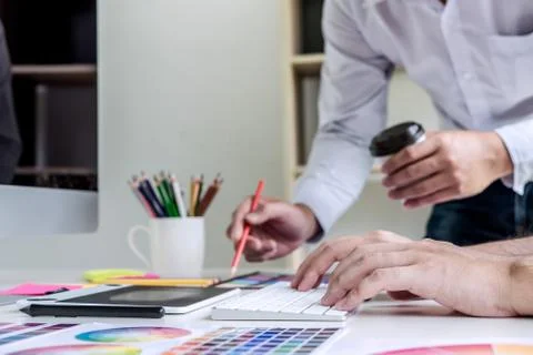 Two colleagues creative graphic designer working on color selection and drawi Stock Photos