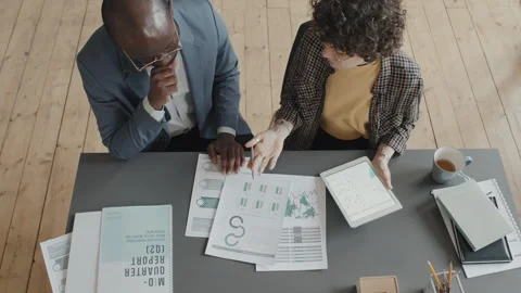 Two Colleagues at Desk Comparing Project Results Stock Footage 242601085
