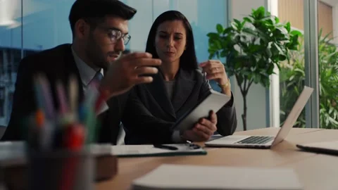 Two colleagues discuss data analyzing marketing using laptop or notebook  Stock Footage 200141623