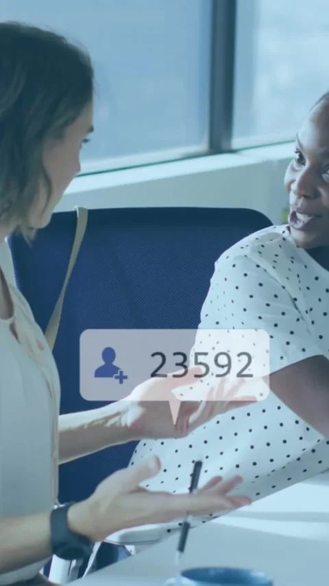 Two colleagues discuss their work on a laptop Stock Footage 343902316