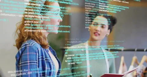 Two colleagues discussing code snippets in office with binder, plant, clothin Stock Photos
